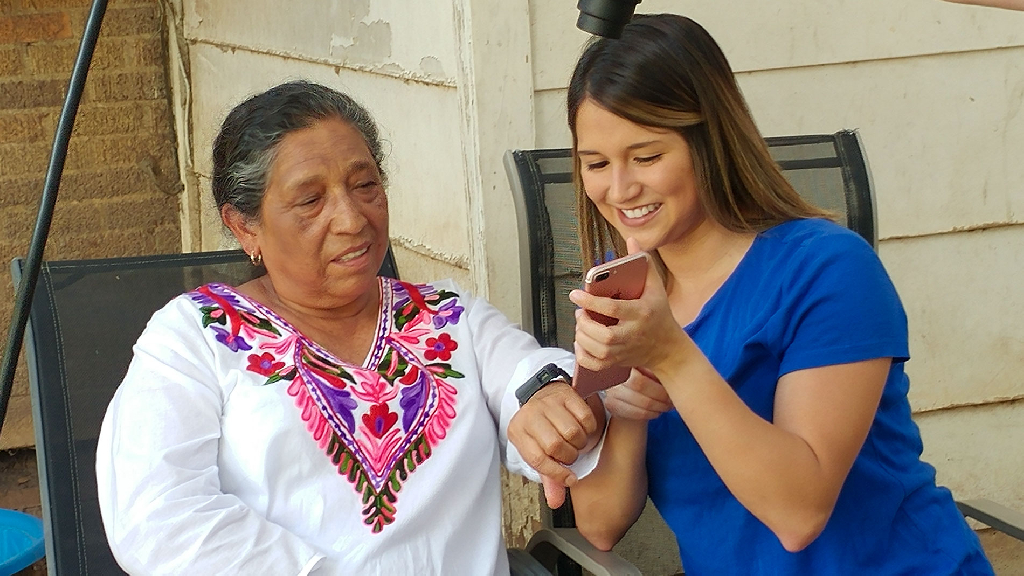 Girl Testing on Health App to Older Lady